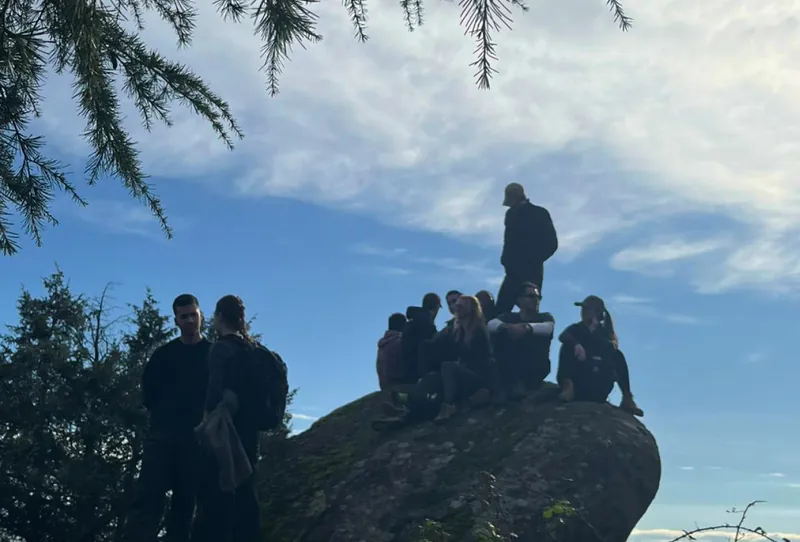 The team hiking at sunset