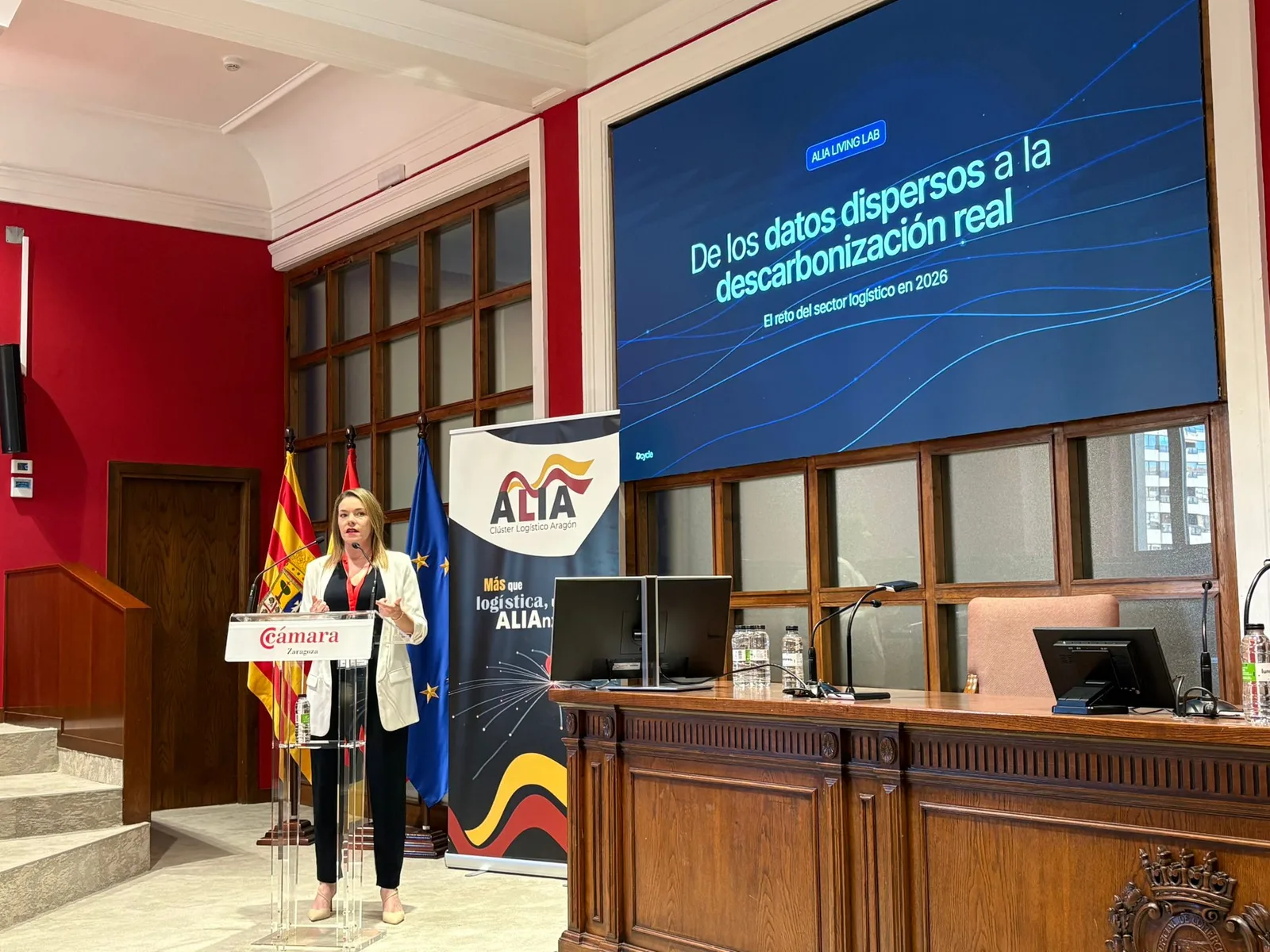 Carla de Reparaz presenting at the ALIA Living Lab with the title slide on screen: from scattered data to real decarbonization